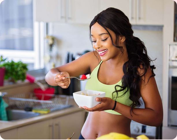 A person eating a bowl of fruits