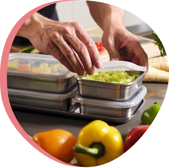 A person preparing healthy meals in containers