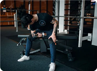 A person sitting and lifting a dumbbell