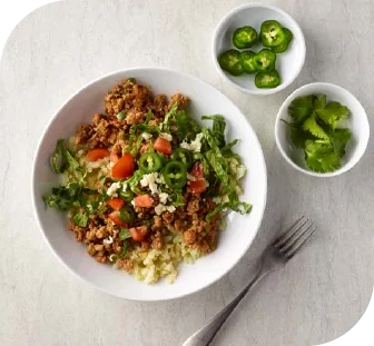 A bowl of a healthy meal with green chili